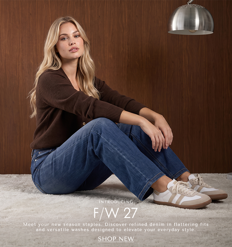 A model sitting on the carpet wearing long sleeve brown cardigan with light blue jeans and sneakers. Text below reading ' Introducing: F/W 27 Meet your new season staples. Discover refined denim in flattering fits and versatile washes designed to elevate your everyday style. CTA 'Shop New'