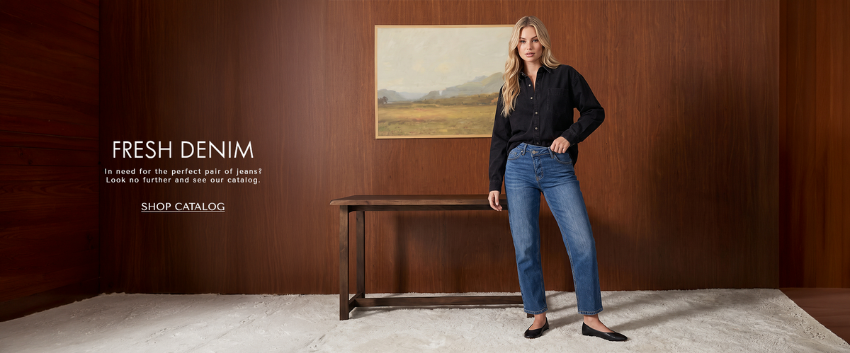 A model wearing black oversized shirt with asymmetrical jeans and black flats. Text reading "Fresh Denim: In need for the perfect of jeans? Look no further and see our catalog.' CTA reading Shop Catalog