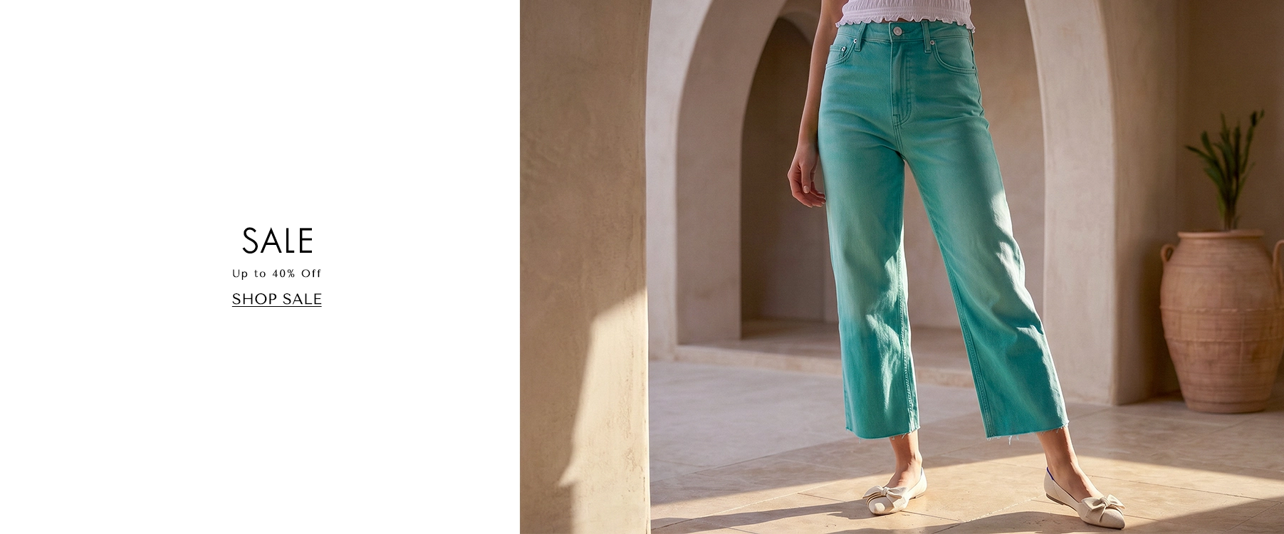 Person wearing teal pants in a sunlit room with a sale banner on the left.